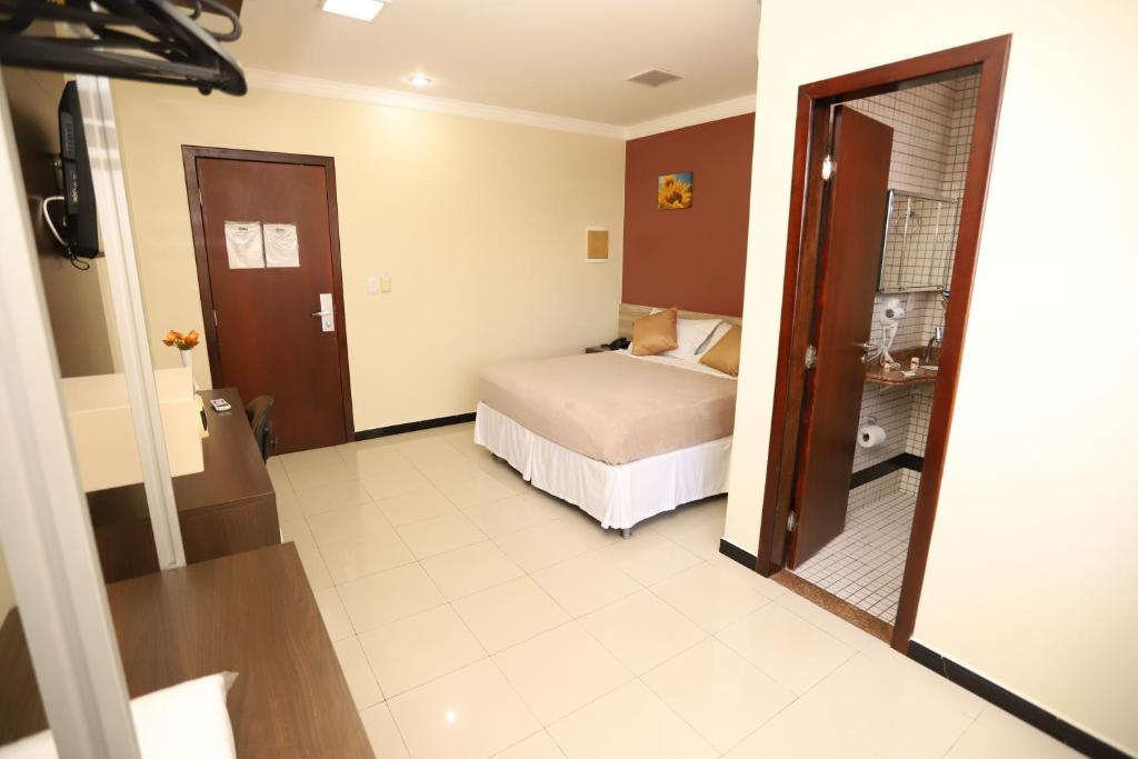 a hotel room with a bed and a bathroom at Hotel Rio Mar in Macapá