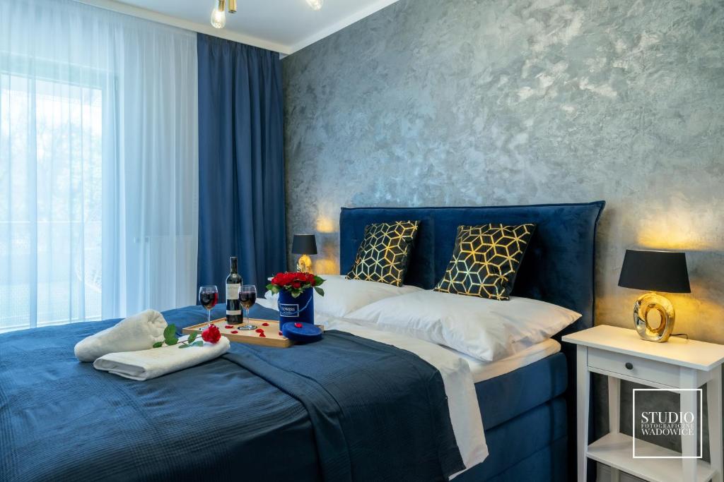 sypialnia z niebieskim łóżkiem z tacą z jedzeniem w obiekcie Exclusive Gold Apartment w Krakowie
