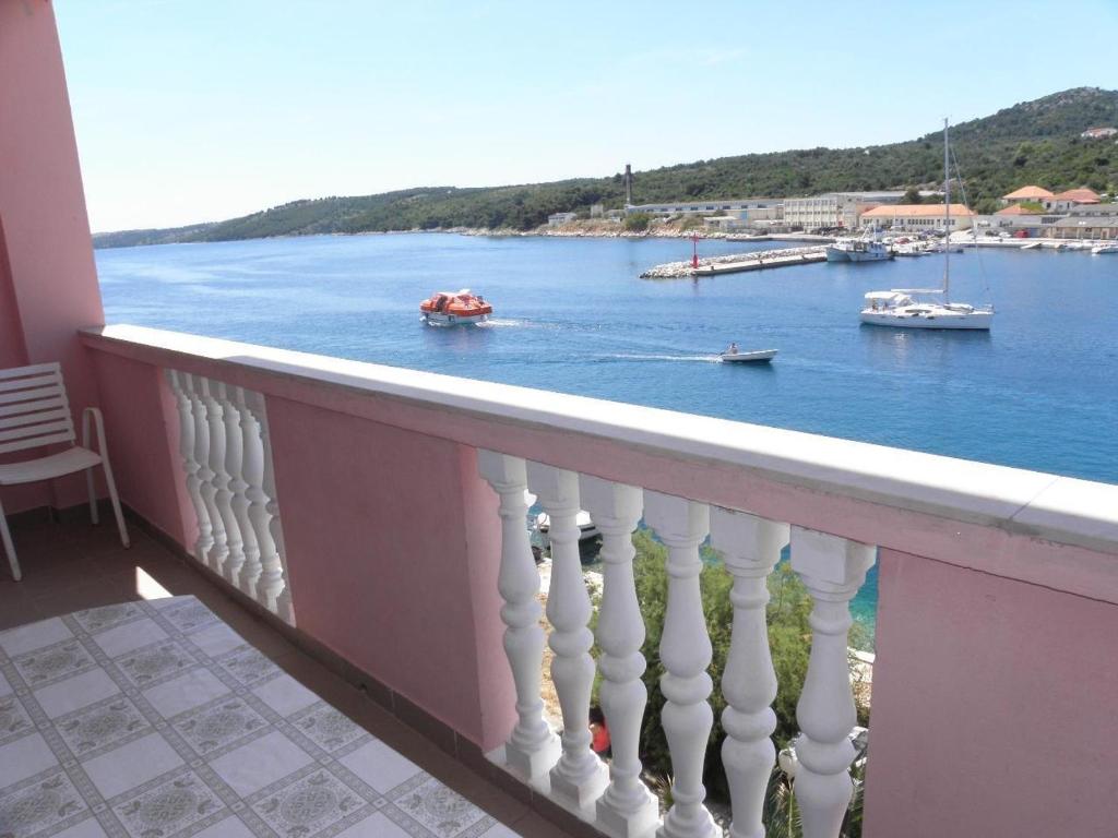 a balcony with a view of a body of water at Apartments Svetka - 10m from the sea in Sali