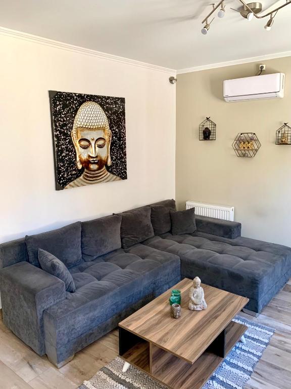 a living room with a blue couch and a table at Leo's city apartment in Lefkada