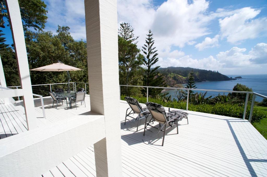 two views of the ocean from a house balcony at Forrester Court Cliff Top Cottages in Cascade