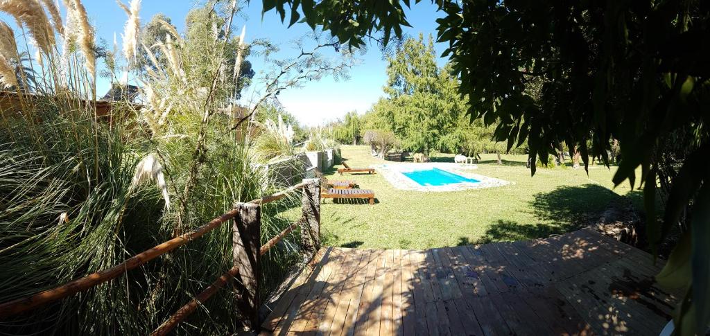 a backyard with a fence and a swimming pool at Pircas de Puyuta in San Juan