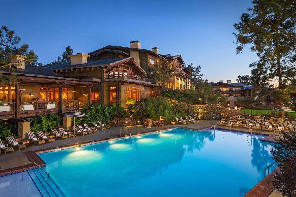 a large swimming pool in front of a house at The Lodge at Torrey Pines in San Diego