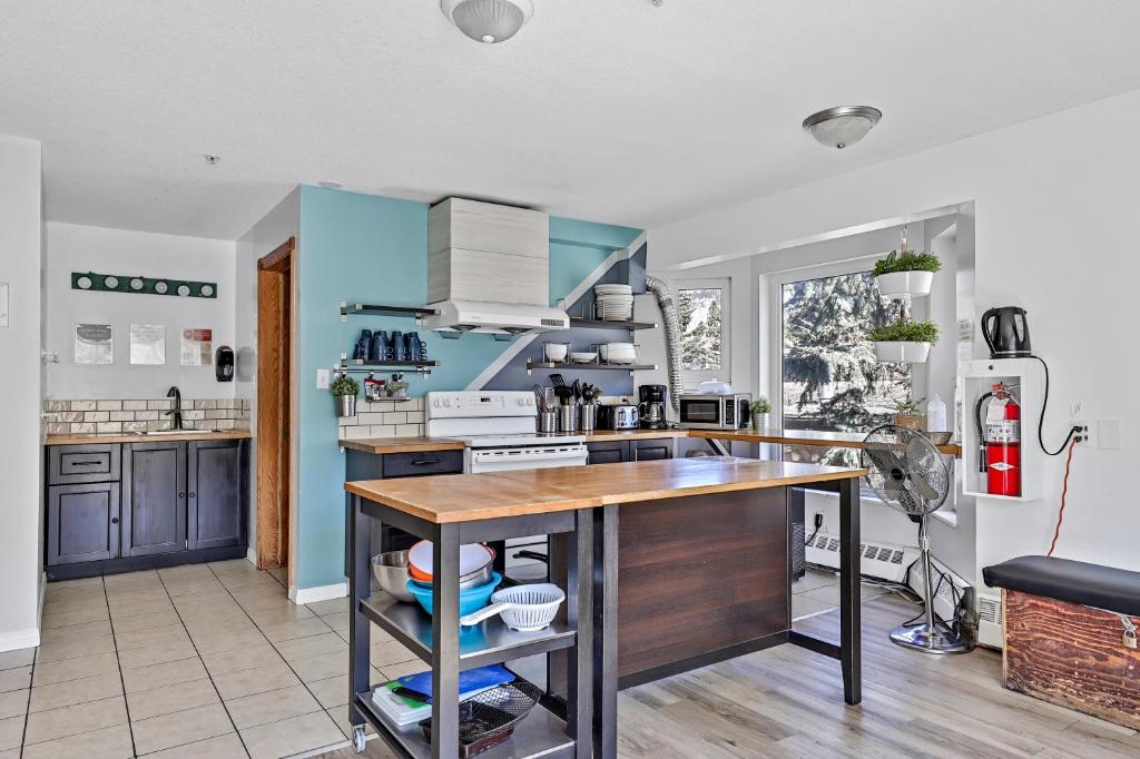 a kitchen with blue walls and a wooden counter top at Samesun Banff Hostel in Banff