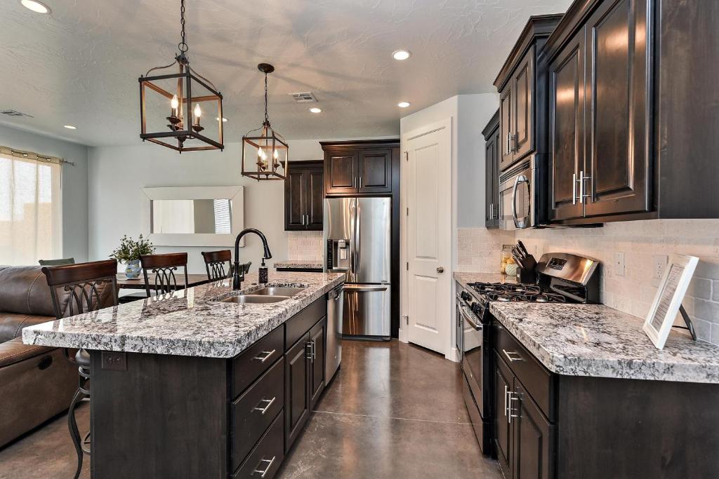 a kitchen with wooden cabinets and granite counter tops at Desert Cool in Ivins