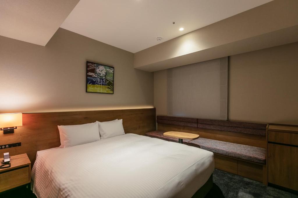 a hotel room with a bed and a projection screen at Hotel Forza Osaka Namba in Osaka