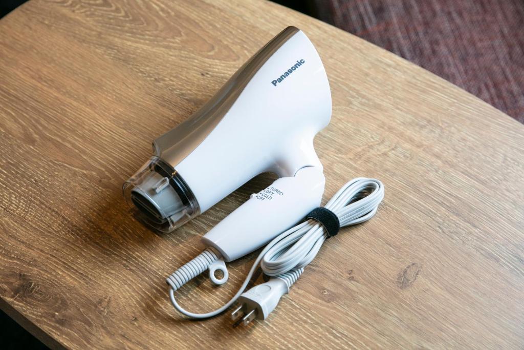 a hair dryer and a hair brush on a table at Hotel Forza Osaka Namba in Osaka