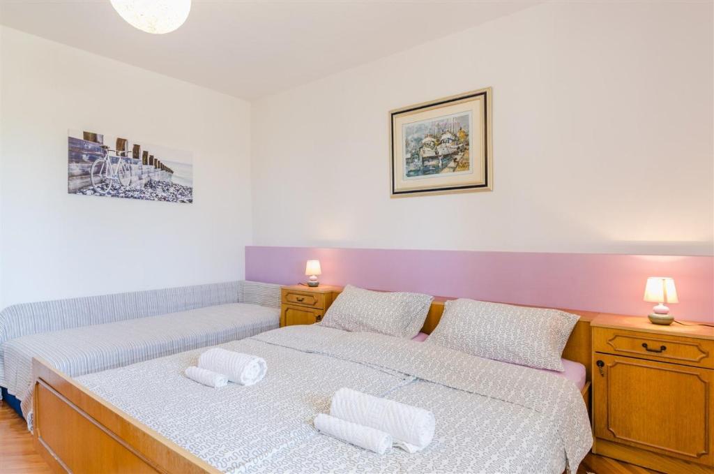 Postel nebo postele na pokoji v ubytování Apartments Rajna