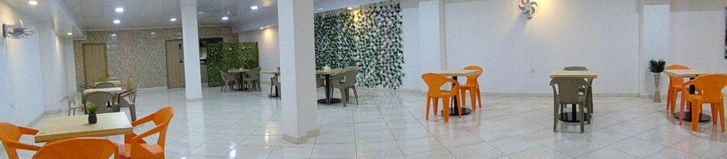a room with tables and chairs in a building at Hotel Paradise del Cafe in Pereira