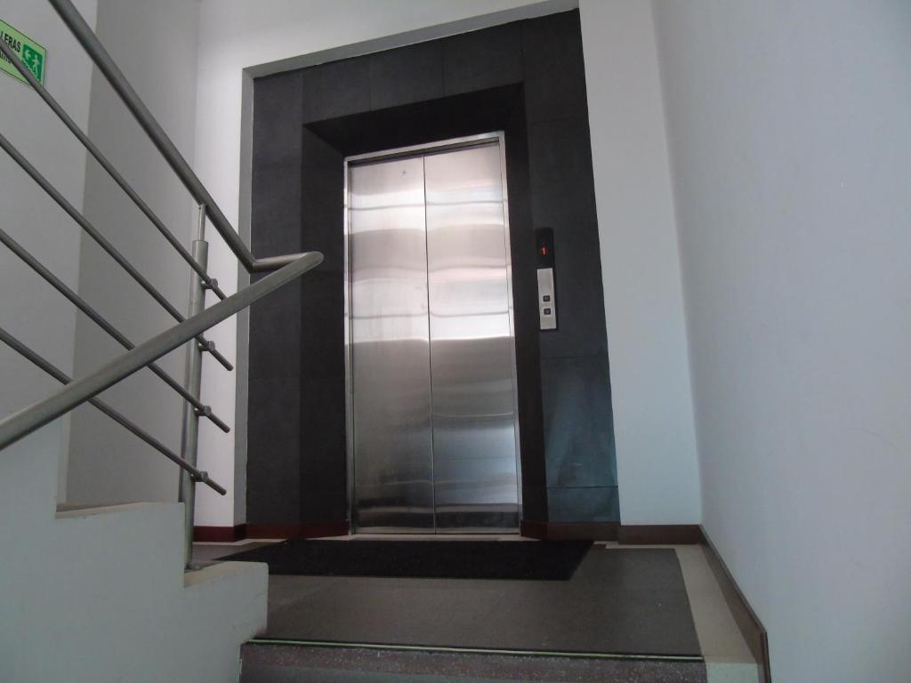 a hallway with a metal elevator in a building at Hotel Paradise del Cafe in Pereira