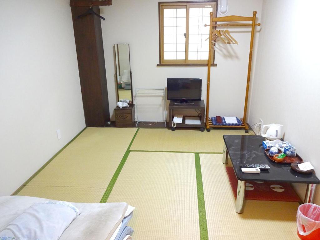 Postel nebo postele na pokoji v ubytování Imazato Ryokan