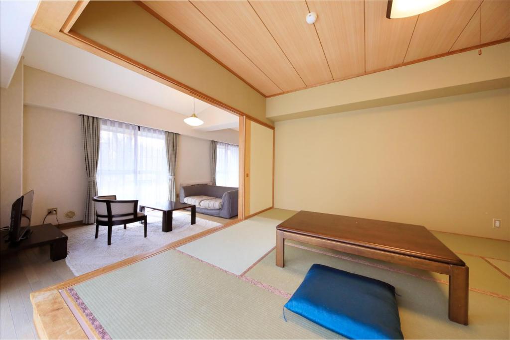 Postel nebo postele na pokoji v ubytování Kishutetsudo Karuizawa Hotel