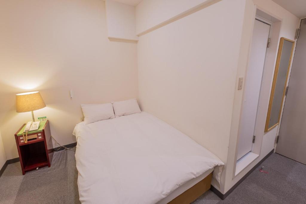 Postel nebo postele na pokoji v ubytování Hotel Kansai