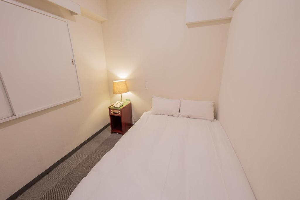 Postel nebo postele na pokoji v ubytování Hotel Kansai
