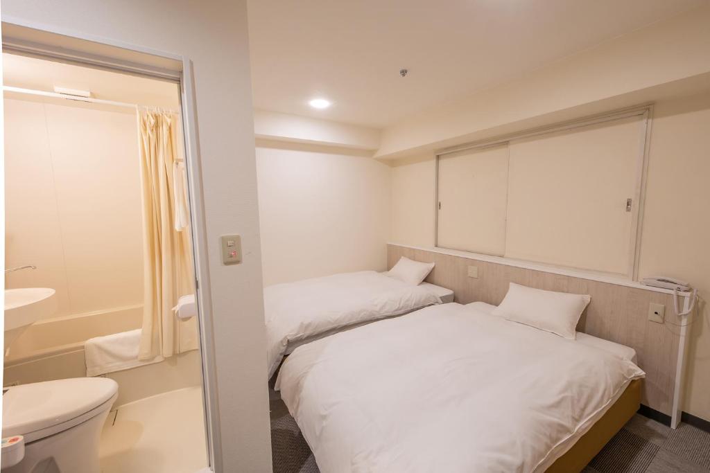 Postel nebo postele na pokoji v ubytování Hotel Kansai