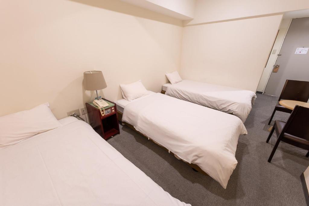 Postel nebo postele na pokoji v ubytování Hotel Kansai