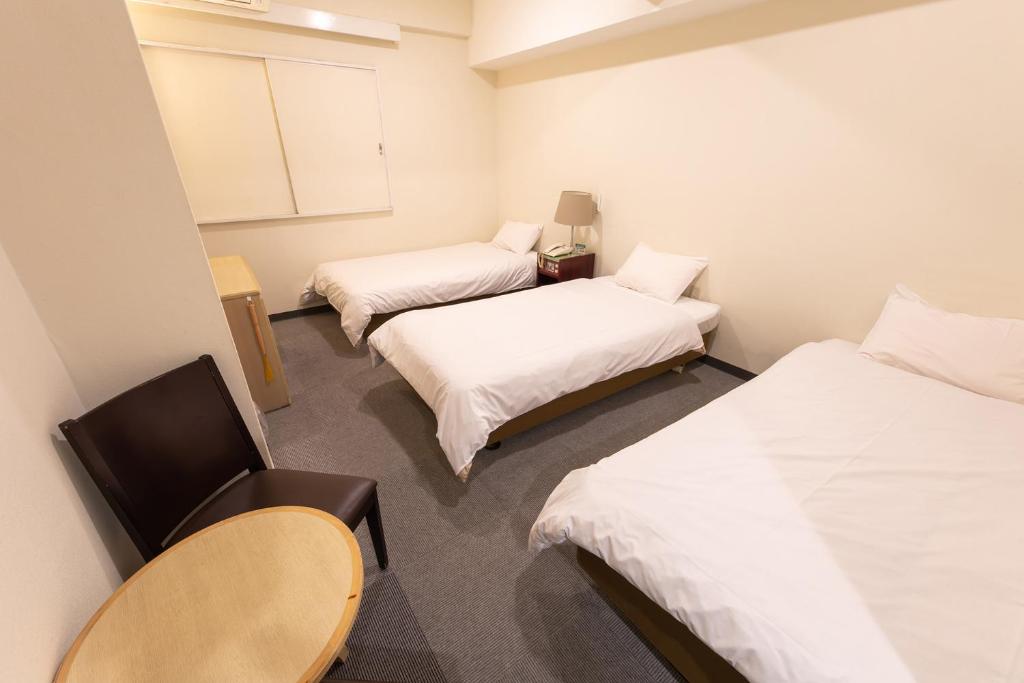 Postel nebo postele na pokoji v ubytování Hotel Kansai