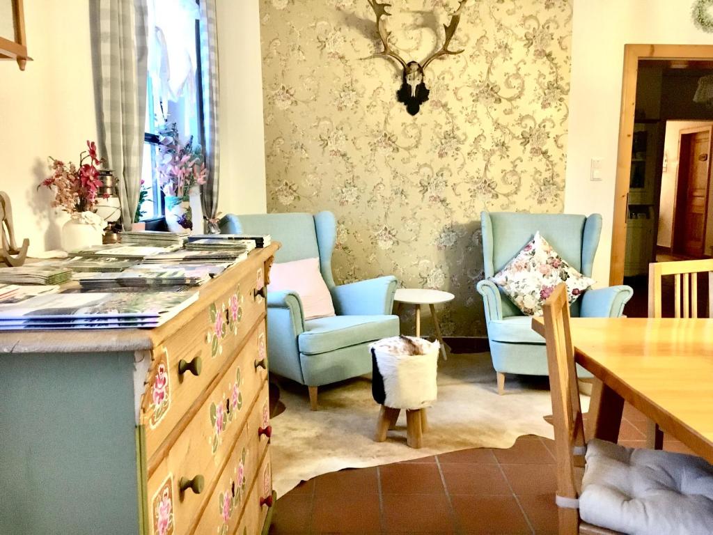 a kitchen with two blue chairs and a table at Landhaus Weinblick in Rohrendorf bei Krems