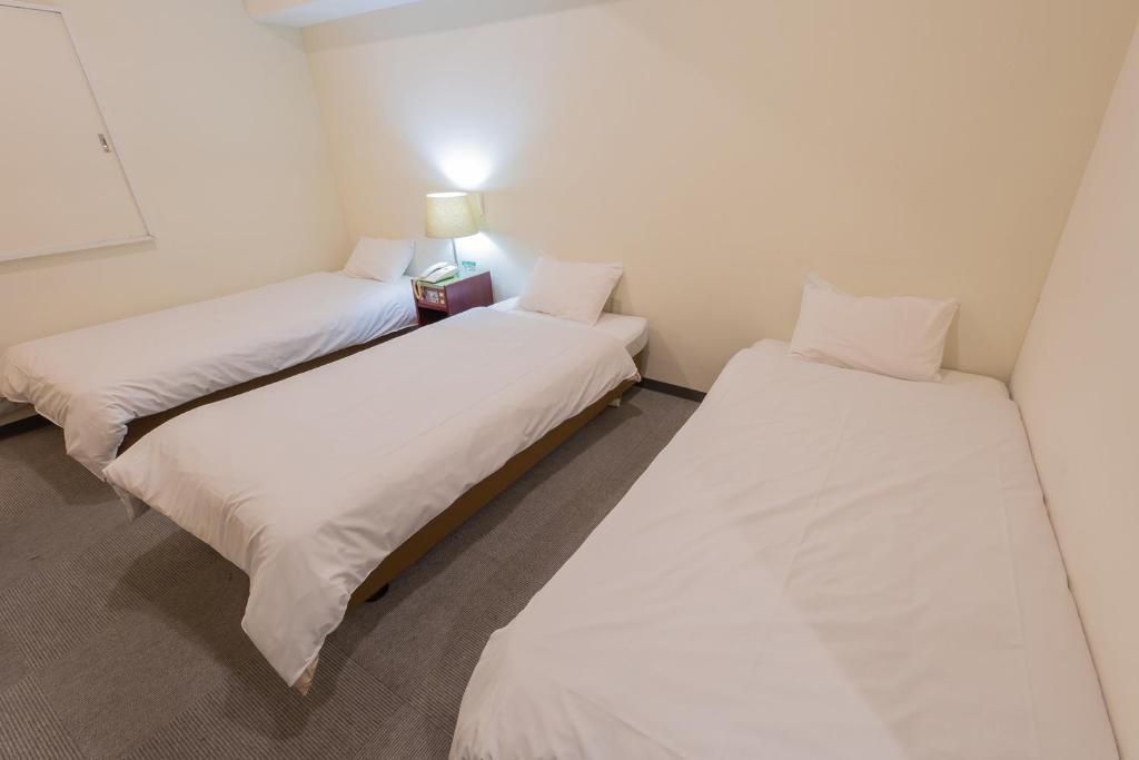 Postel nebo postele na pokoji v ubytování Hotel Kansai