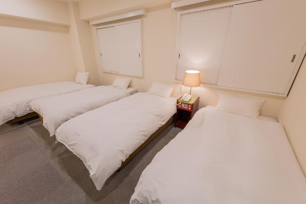 Postel nebo postele na pokoji v ubytování Hotel Kansai