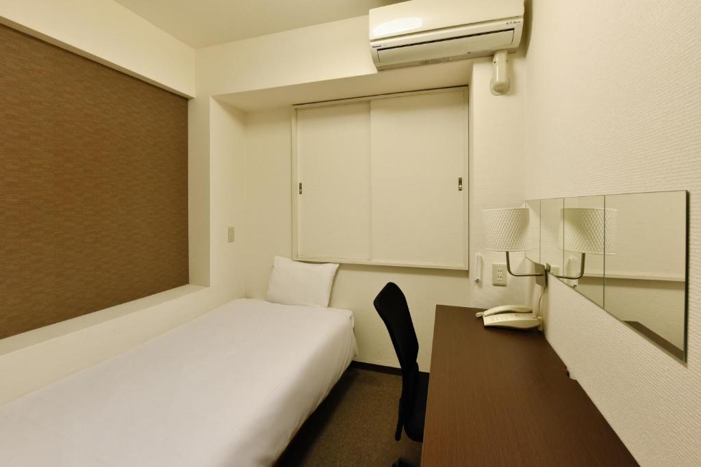 Postel nebo postele na pokoji v ubytování Hotel Kansai