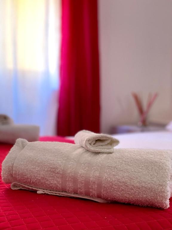 a pair of towels sitting on top of a bed at B&b Kamaraton in Marina di Camerota