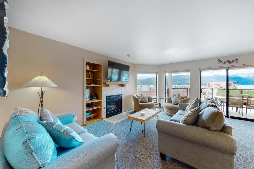 a living room with two couches and a fireplace at Lake Chelan Shores Shore Serenity 19-3 in Chelan