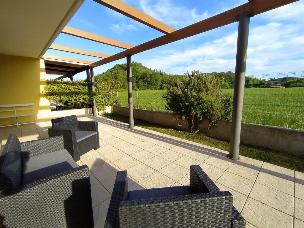a patio with chairs and a view of a field at Ca' Emma Teolo in Teolo