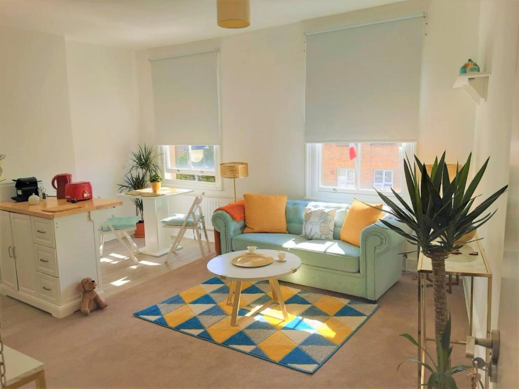 a living room with a couch and a table at Julian apartment center of London in London