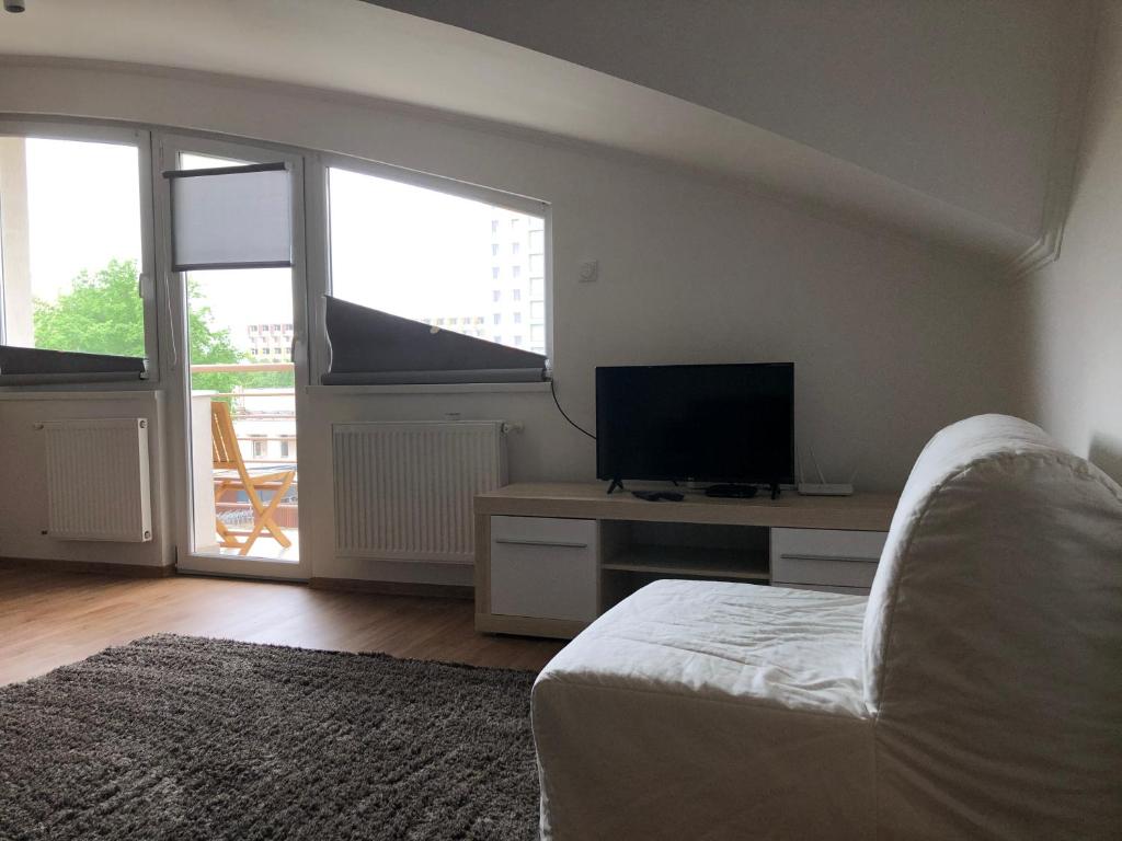 Televízia a/alebo spoločenská miestnosť v ubytovaní Sunrise 3 Apartment