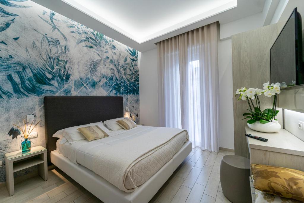 a bedroom with a bed and a painting on the wall at Hotel Stella D'Oro in Rimini