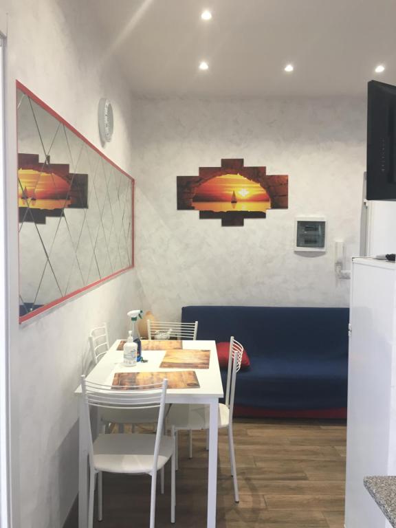 a dining room with a white table and chairs at IN CENTRO A RAPALLO in Rapallo