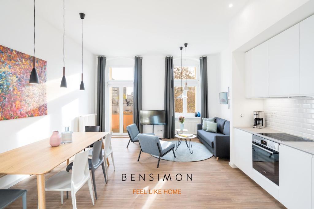 a kitchen and living room with a table and chairs at BENSIMON apartments Mitte/Wedding in Berlin
