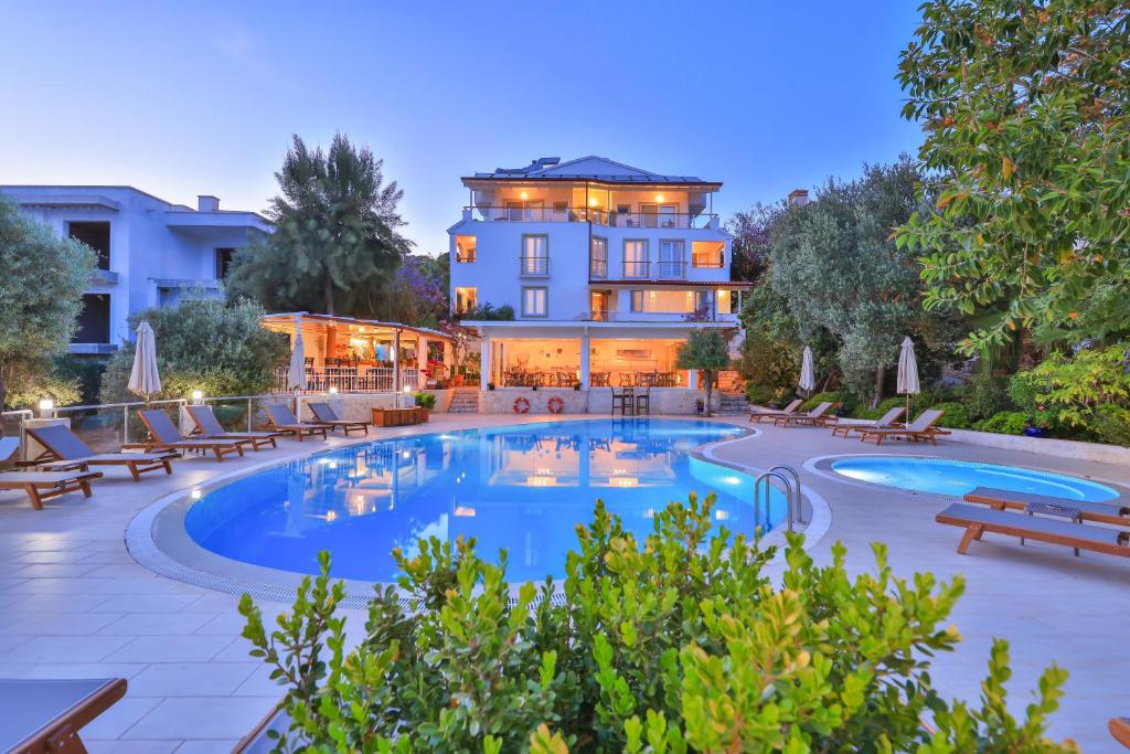 a hotel with a pool in front of a building at Olea Nova Hotel in Kas