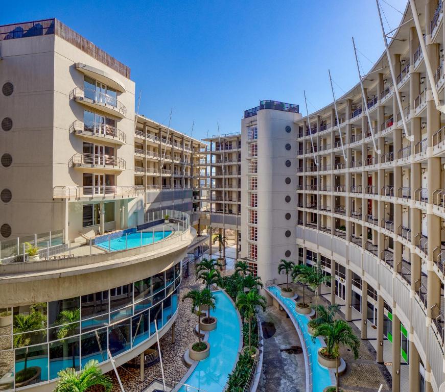 an apartment complex with a swimming pool and two buildings at The Sails G6-07 on Timeball Boulevard in Durban