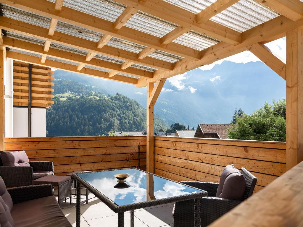 a patio with a table and chairs and a view at Schneggnheisl - Appartement in Sautens