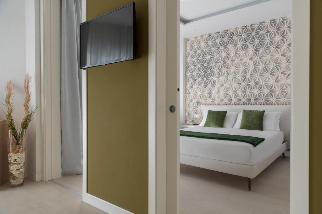Postel nebo postele na pokoji v ubytování Hotel Delle Rose