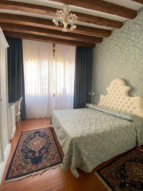 Postel nebo postele na pokoji v ubytování Locanda Casa Querini