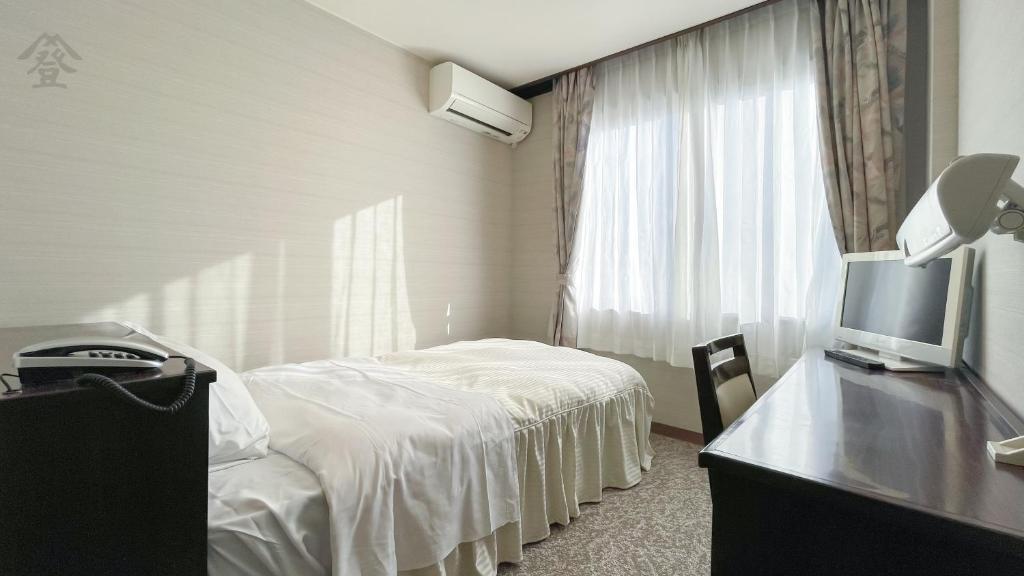 Postel nebo postele na pokoji v ubytování Hotel Kawaguchiko