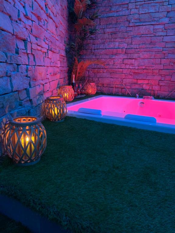 a hot tub in a room with a brick wall at La collina di Capodimonte in Naples