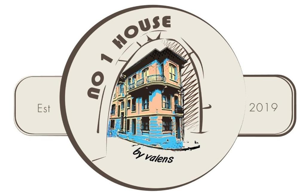 a clock with a picture of a house at No 1 House By Valence in Istanbul