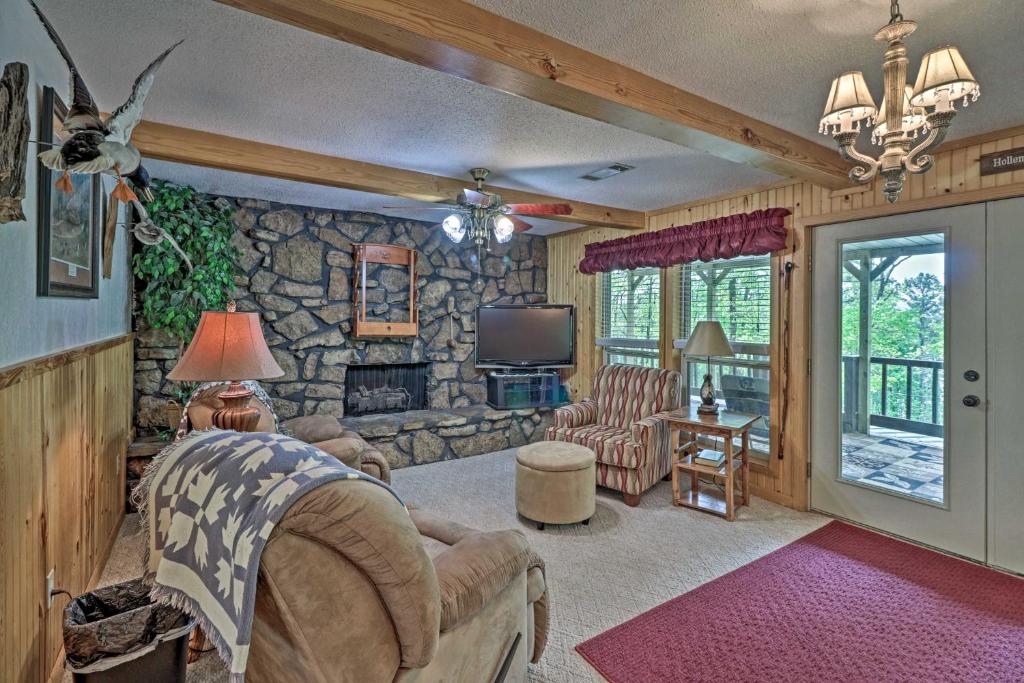 a living room with a stone wall at Secluded Edgemont Getaway with Huge Outdoor Deck! in Fairfield Bay