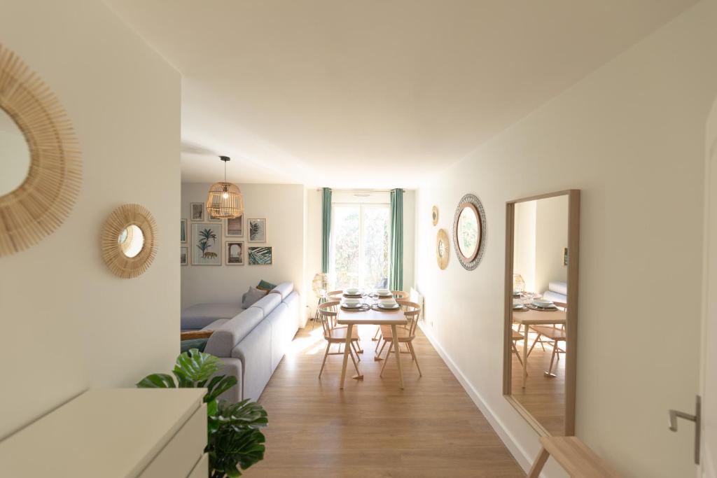 un salon avec un canapé et une salle à manger dans l'établissement Suite Tropical Disneyland Paris - Jardin privé !, à Montévrain