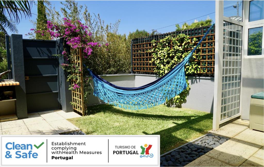 a hammock on a fence in a garden at Casa Mar e Serra in Cascais