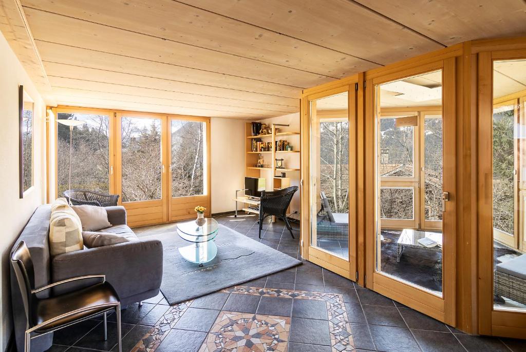a living room with a couch and a table at Chalet Steingärtli 1 in Wengen