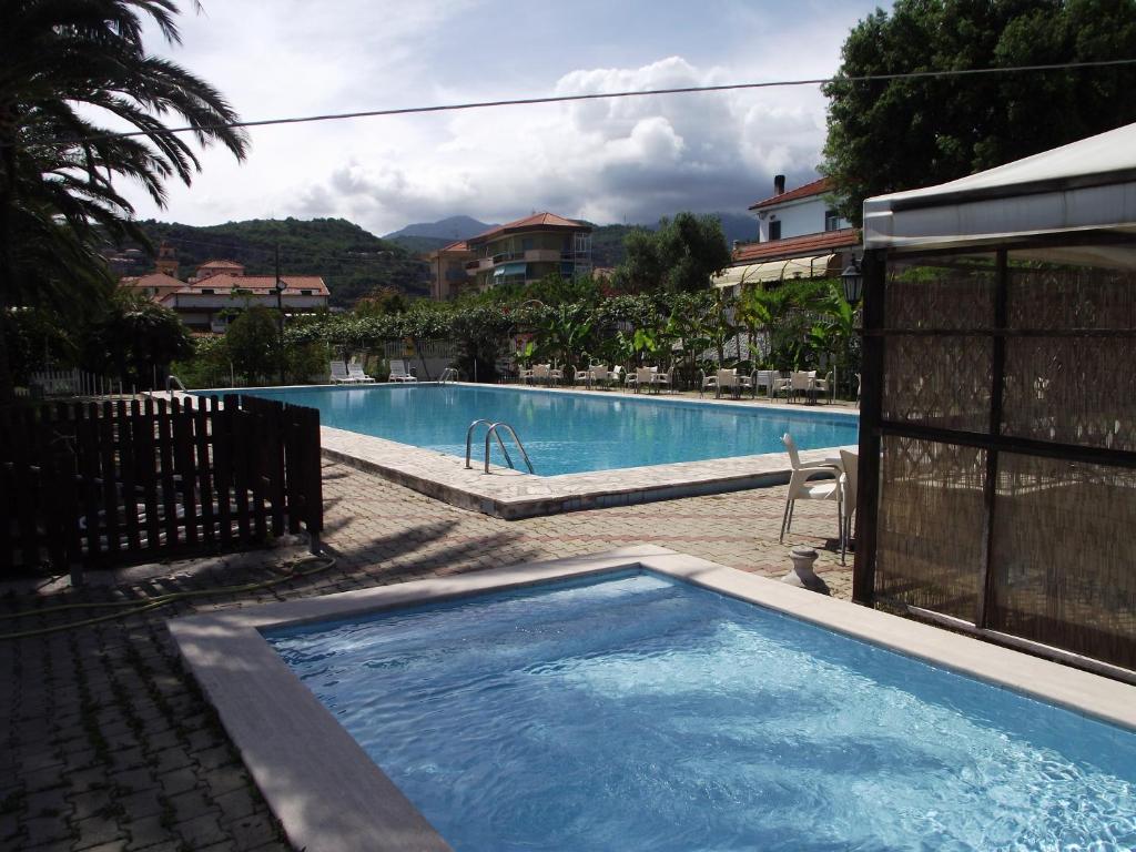 a large swimming pool in a resort at Bike and Breakfast Apartments in Pietra Ligure