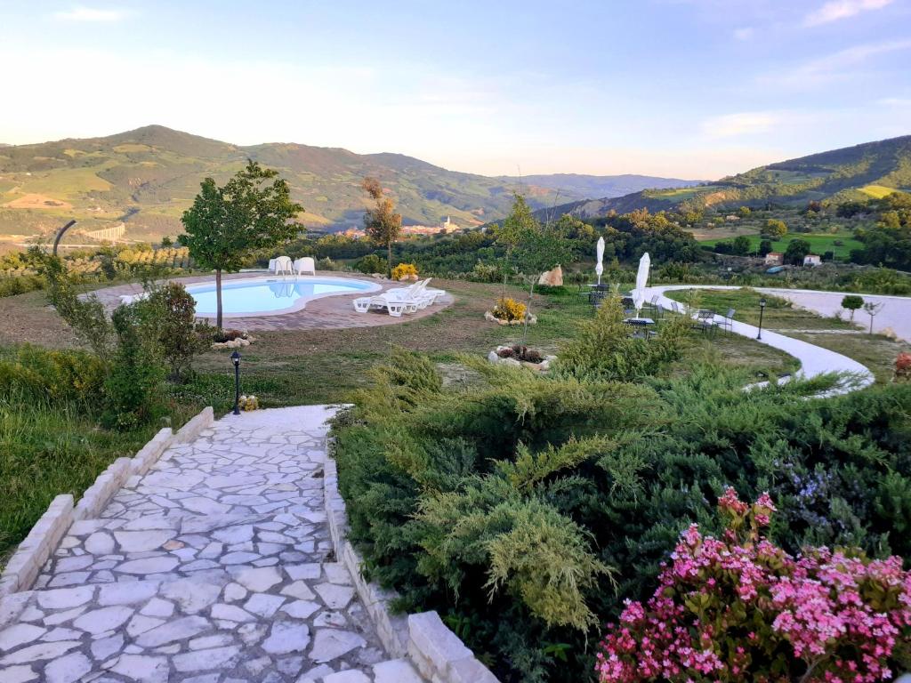 a garden with a swimming pool and flowers at Le Terre Del Sacramento in Guardialfiera