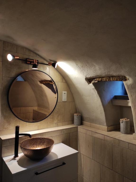 a bathroom with a sink and a mirror at PARFUMU DI MACHJA in Santa-Lucia-di-Mercurio