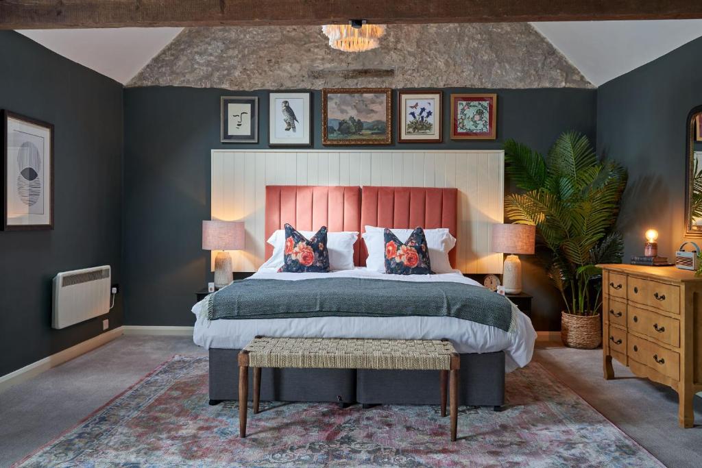 a bedroom with a large bed with blue walls at The Langford Inn in Langford