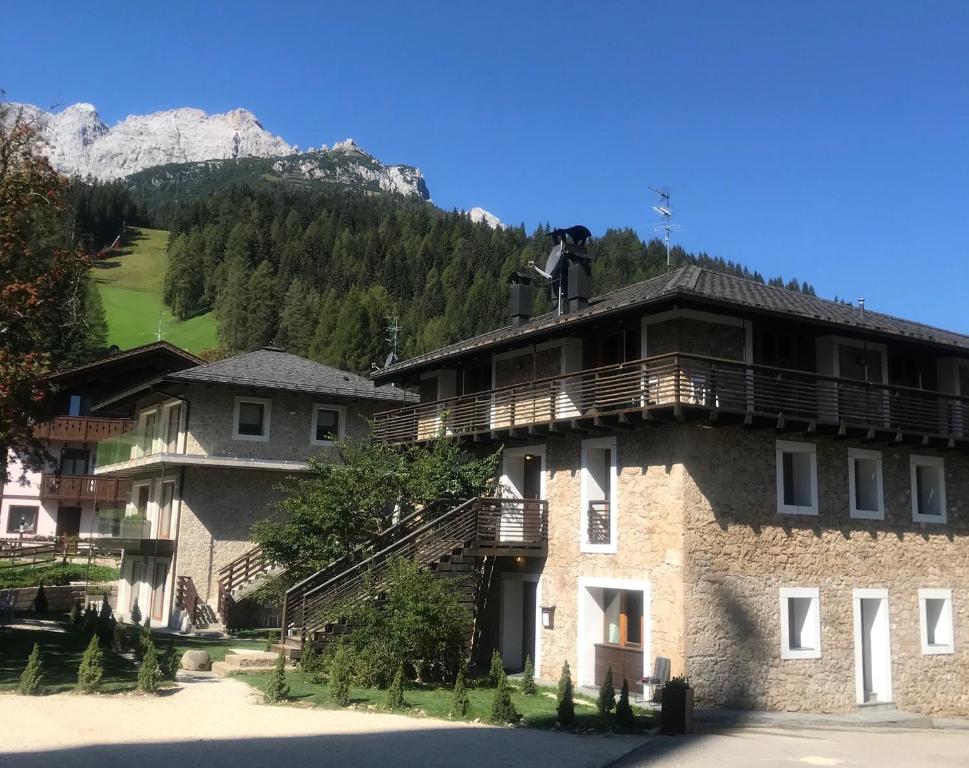 a large building with a balcony on top of it at Comelico Chalet in Padola